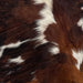 Closeup of this XS, Tricolor Cowhide, showing a mix of reddish brown, black, and white (XS224)