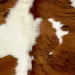 Closeup of this XS Tricolor Cowhide, showing a brown and black, brindle pattern and large and small, white spots (XS545)