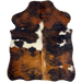 XS Tricolor Cowhide: has a reddish brown and black, brindle pattern, and a few large and small, white spots - 4'4" x 3'4" (XS600)