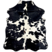 XS Black and White Cowhide: white with large and small, black spots, some having white speckles, and it has a touch of brown, and longer hair, on the spine - 4'6" x 3'5" (XS607)