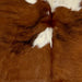 Closeup of this XS Tricolor Cowhide, showing brown with small and large, white spots, and a few black, brindle markings  (XS611)