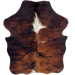 XS Red Brown and Black Brindle Cowhide:    has long hair that is red brown with black, brindle markings, and one large, white spot in the middle of the shoulder and a small, white spot on the right side of the back  - 4'5" x 3'5" (XS721)