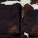 Closeup of this XS Tricolor Cowhide, showing a mix of black and brown, and a few white spots (XS795)