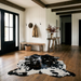 Tricolor cowhide rug CH-008 in a modern farmhouse entry hall with shiplap walls, a black front door, wooden bench and coat hooks