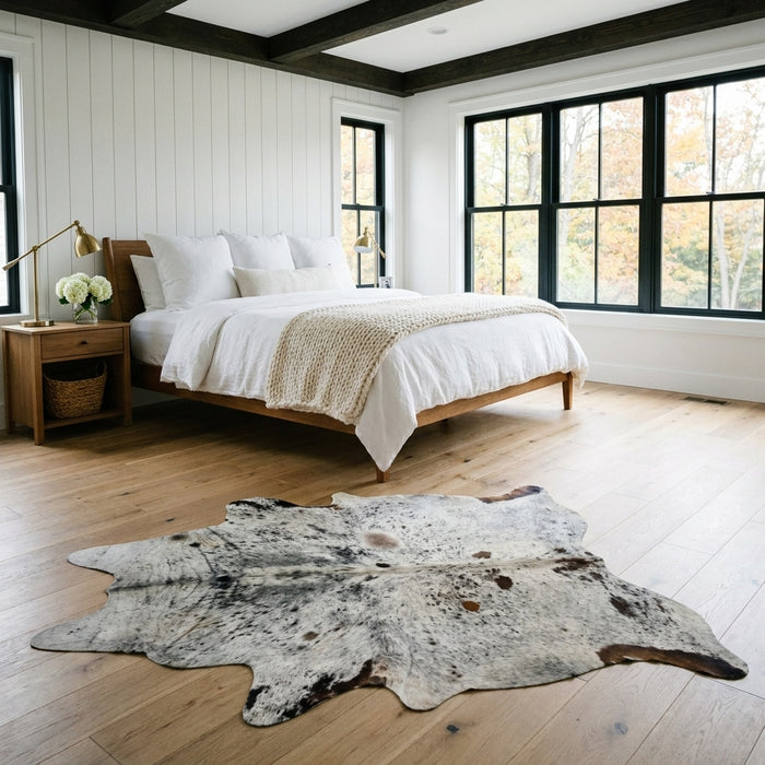 Salt and pepper Brazilian cowhide rug in a bright modern farmhouse bedroom with light oak floors