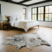 Salt and pepper Brazilian cowhide rug in a bright modern farmhouse bedroom with light oak floors