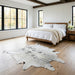 Salt and pepper Brazilian cowhide rug in a bright modern farmhouse bedroom with light oak floors