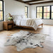 Salt and pepper Brazilian cowhide rug in a bright modern farmhouse bedroom with light oak floors
