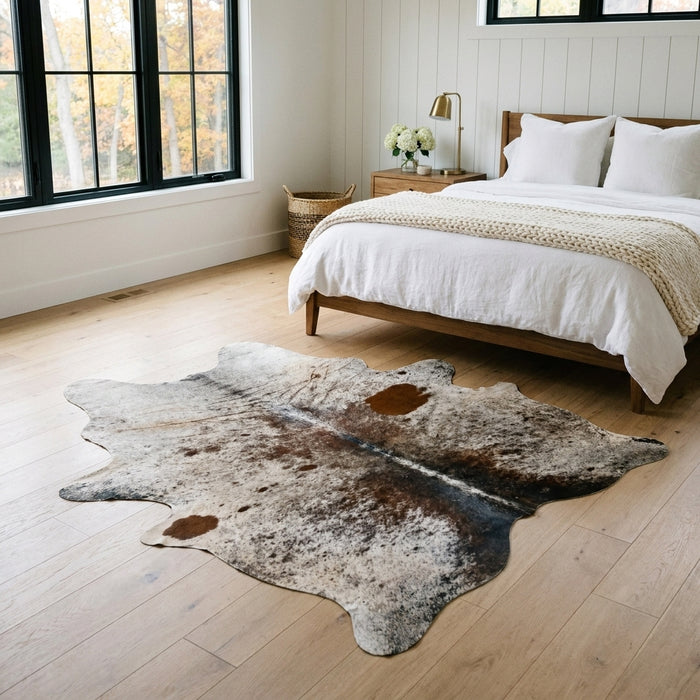 Salt and pepper Brazilian cowhide rug in a bright modern farmhouse bedroom with light oak floors
