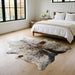 Salt and pepper Brazilian cowhide rug in a bright modern farmhouse bedroom with light oak floors