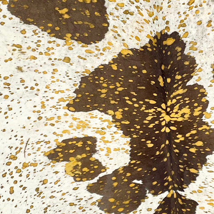 Closeup of this Brazilian Cowhide that is white with large brown spots, and it has been treated with a Yellow Acid Wash (BRAW268)