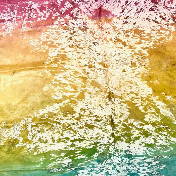Closeup of this XL, Brazilian Cowhide that has a rainbow acid wash  in pink, yellow, green, and turquoise (BRAW306)
