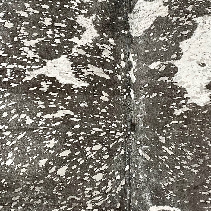 Closeup of this Dark brown and white, Brazilian cowhide, showing a silver, metallic acid wash (BRAW355)