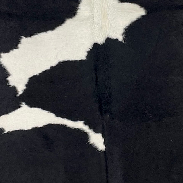 Closeup of this XL, Black and White, Brazilian Cowhide, showing black with two of the three large, white spots down the middle (BRBKW221)