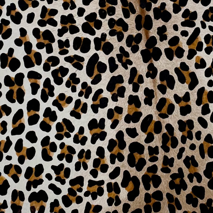 Closeup of this Brazilian Calfskin that is white with brown down the middle, showing a stenciled brown and black, Leopard Print (BRCALF550)