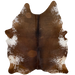 Large Brown and White Speckled Brazilian Cowhide:  mostly solid brown in the middle, with a few white speckles, and white and off-white with brown speckles on the belly and along the lower edge - 7'9" x 6' (BRSP1696)