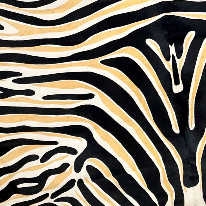 Closeup of this Large, Off-White, Brazilian Cowhide that has been stenciled with a black and yellow zebra print (BRZP029)