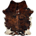 Colombian Tricolor Cowhide:  has hair, with a curly texture, that has a red brown and black, brindle pattern, with a couple small, white spots in the middle of the shoulder, and off-white on the belly and hind shanks - 6'10" x 5' (COTR834)