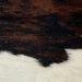 Closeup of this Tricolor, Mini Cowhide that has a mix of brown and black across the shoulder and the lower edge, and off-white across the middle (MINI170)